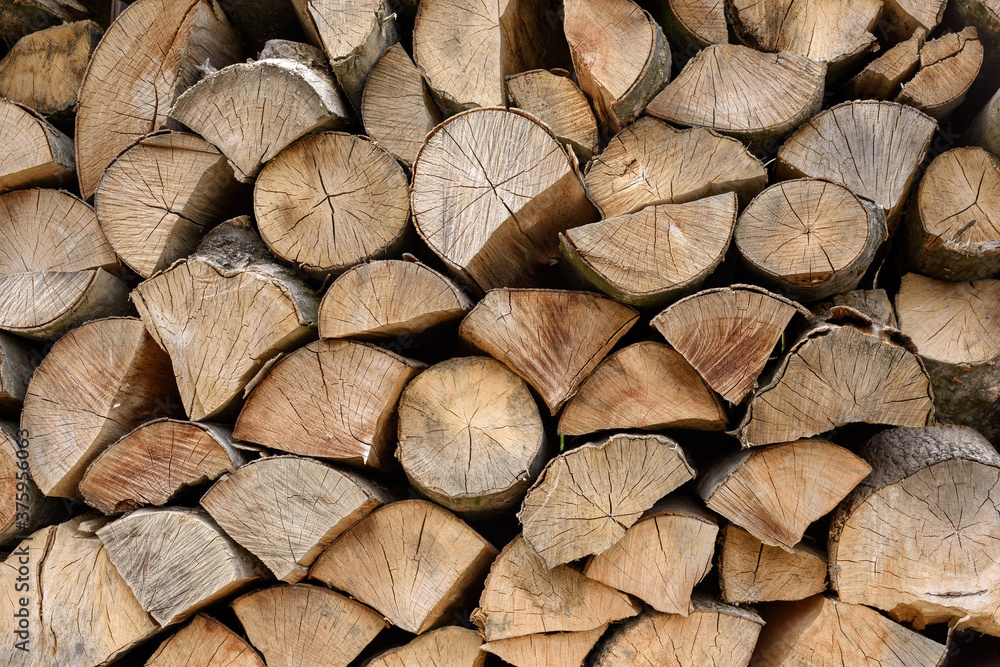 Wall of firewood, background of dry chopped firewood. Alternative fuel concept. Wooden background. Natural texture. Wall of firewood, background of dry chopped firewood. Alternative fuel concept. Wooden background. Natural texture.