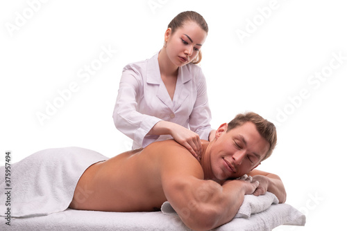 Masseuse doing massage on back of male client