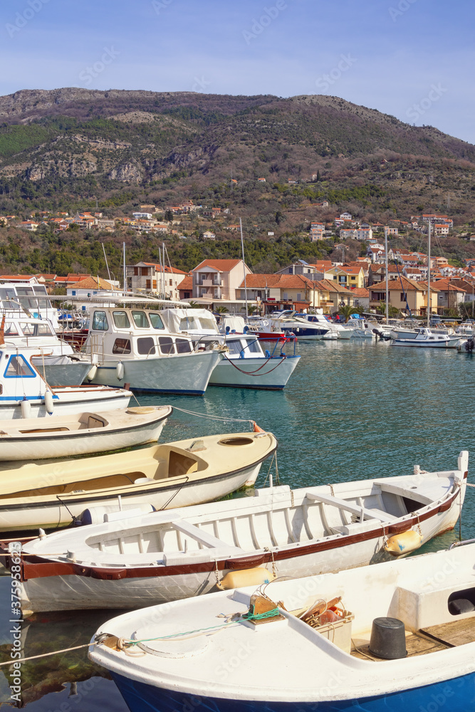 Winter Mediterranean landscape. Fishing boats in harbor. Montenegro, Tivat city, view of marina Kalimanj