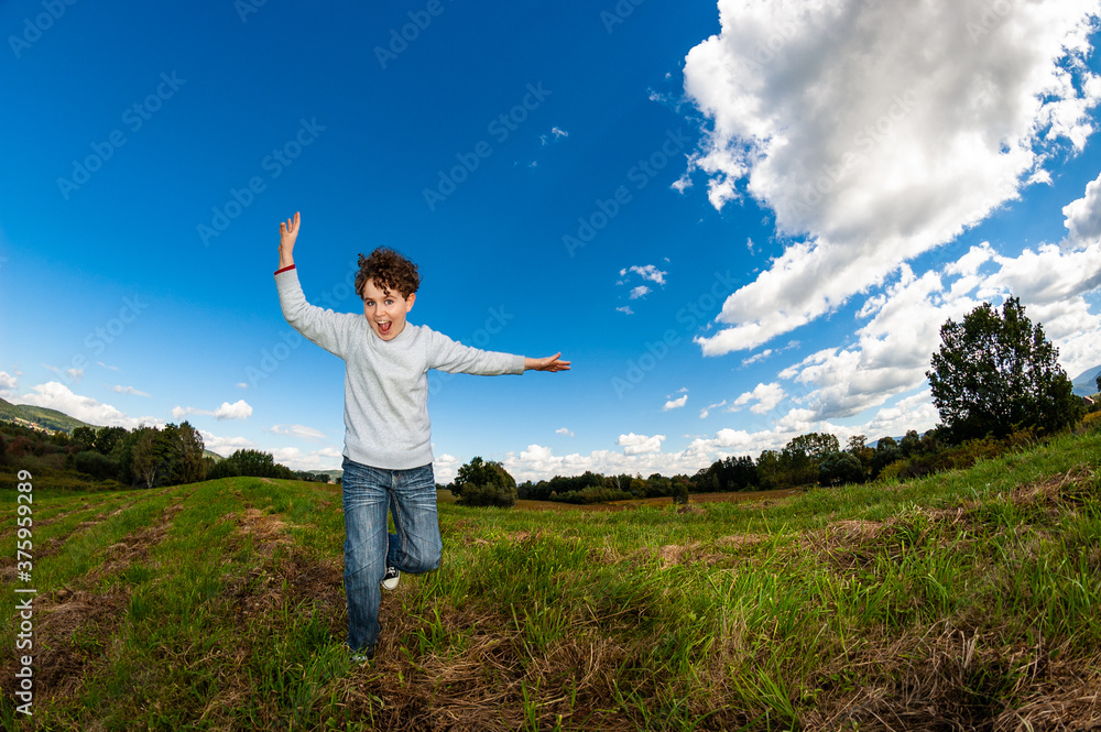 Boy jumping, running against blue sky
Boy jumping, running against blue sky