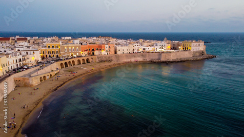 Fototapeta Naklejka Na Ścianę i Meble -  Aerial view of Gallipoli on the Salento peninsula in the south of Italy (Apulia) - Beach of Purity in the old town at sunset