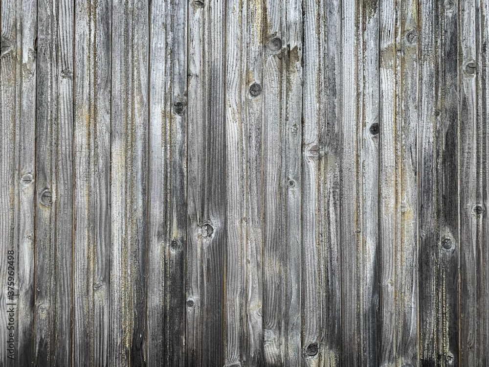 Old rough discolored wooden fence texture / background Old rough discolored wooden fence texture / background