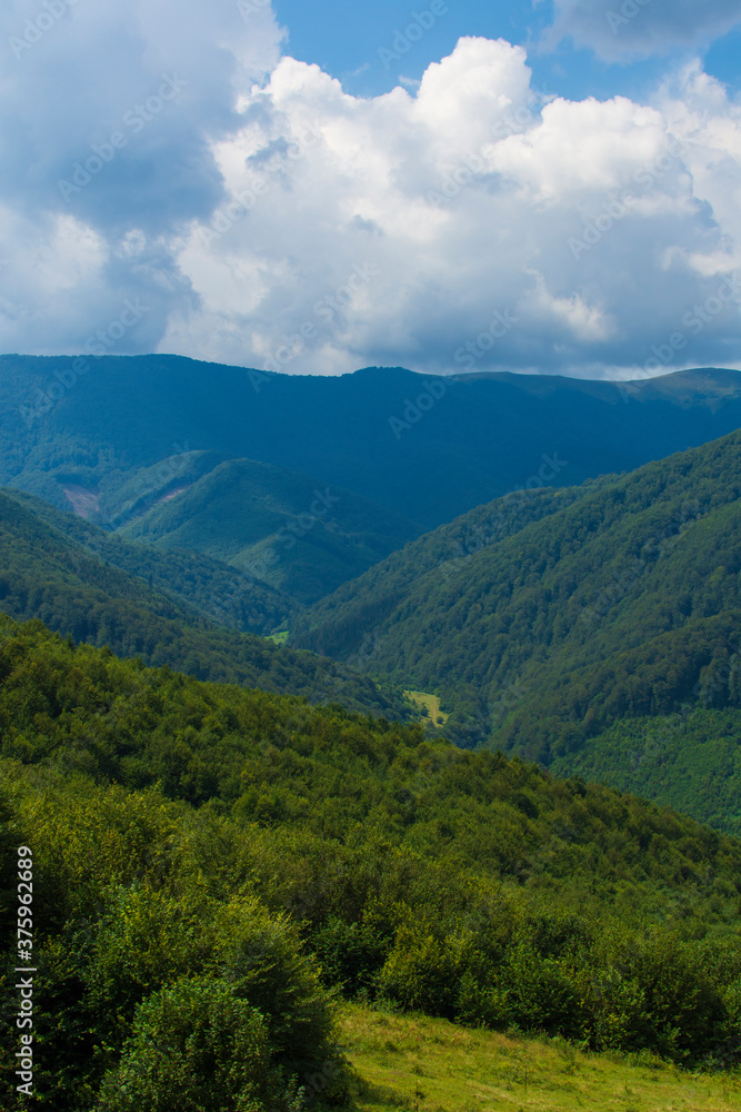 Beautiful landscape with mountains and a cloudy sky in the summer. Vertical image. Beautiful landscape with mountains and a cloudy sky in the summer. Vertical image.