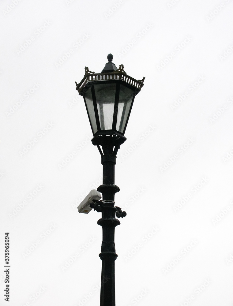 beautiful old vintage street light with surveillance camera