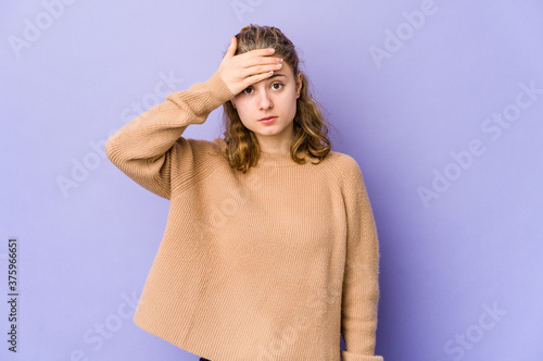 Young caucasian woman on purple background being shocked, she has remembered important meeting.
