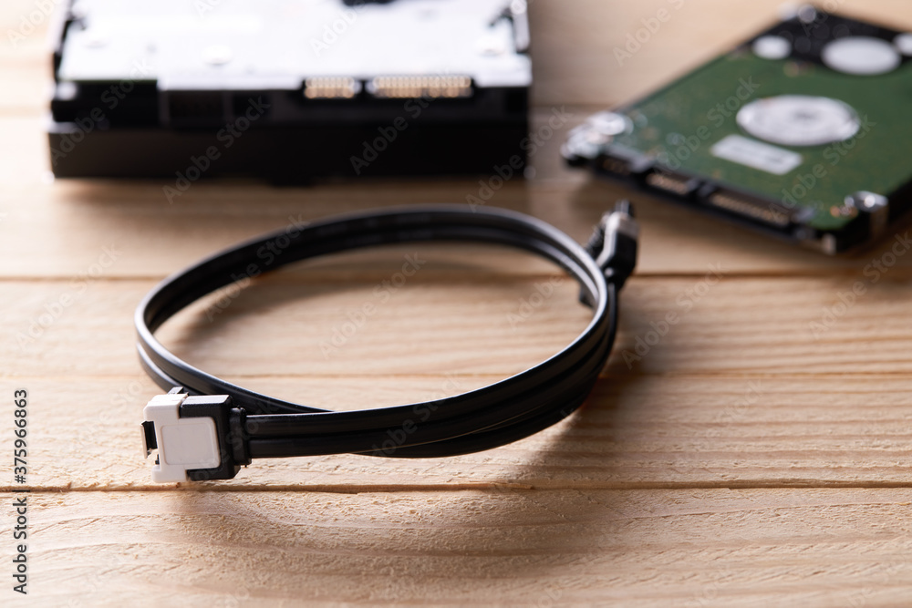 data storage hardware for desktop and laptop computers. backup data technology concept. stack of hard drive disc over wooden background. information recovery conceptual data storage hardware for desktop and laptop computers. backup data technology concept. stack of hard drive disc over wooden background. information recovery conceptual