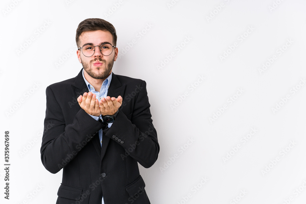 Young caucasian business man posing in a white background isolated Young caucasian business man folding lips and holding palms to send air kiss. Young caucasian business man posing in a white background isolated Young caucasian business man folding lips and holding palms to send air kiss.