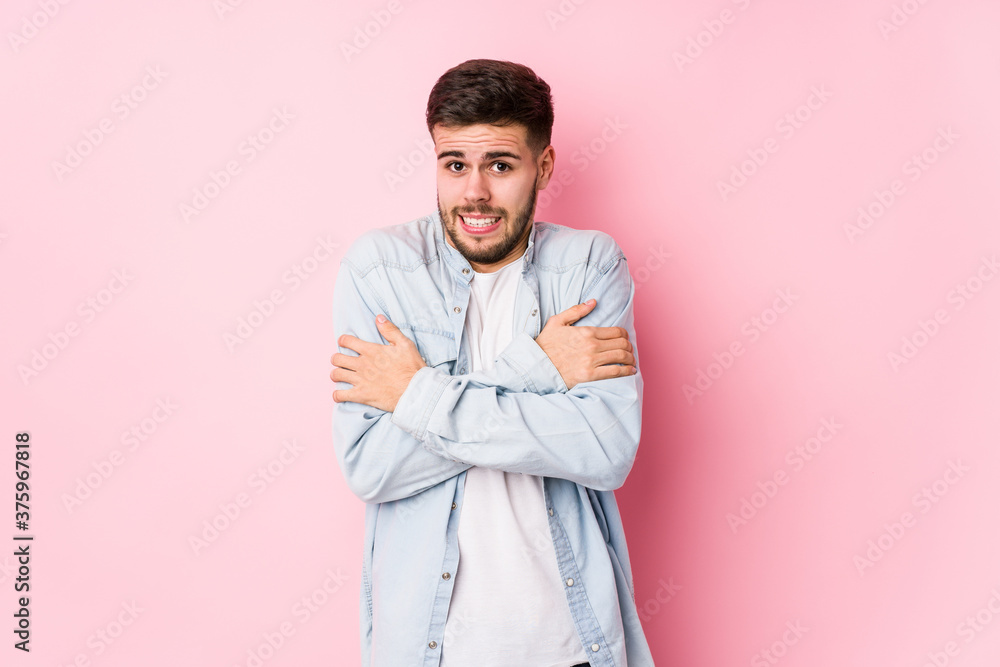 Young caucasian business man posing in a white background isolated going cold due to low temperature or a sickness.< mixto > Young caucasian business man posing in a white background isolated going cold due to low temperature or a sickness.< mixto >