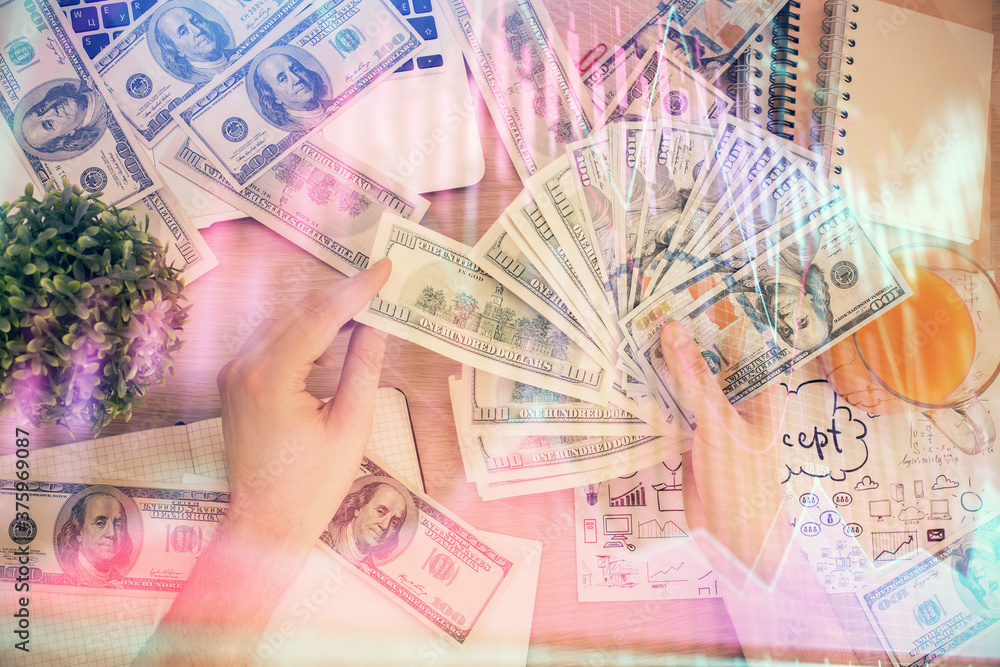 Multi exposure of financial graph drawing hologram and USA dollars bills and man hands. Analysis concept. Multi exposure of financial graph drawing hologram and USA dollars bills and man hands. Analysis concept.