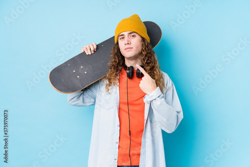 Canvastavla Young caucasian skater man isolated pointing with finger at you as if inviting come closer