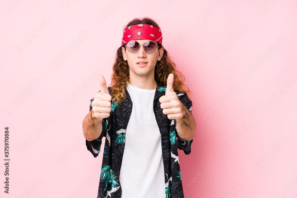 Young hippie caucasian man isolated with thumbs ups, cheers about something, support and respect concept.