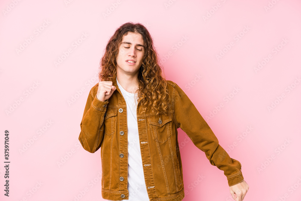 Young long hair man posing isolated dancing and having fun. Young long hair man posing isolated dancing and having fun.