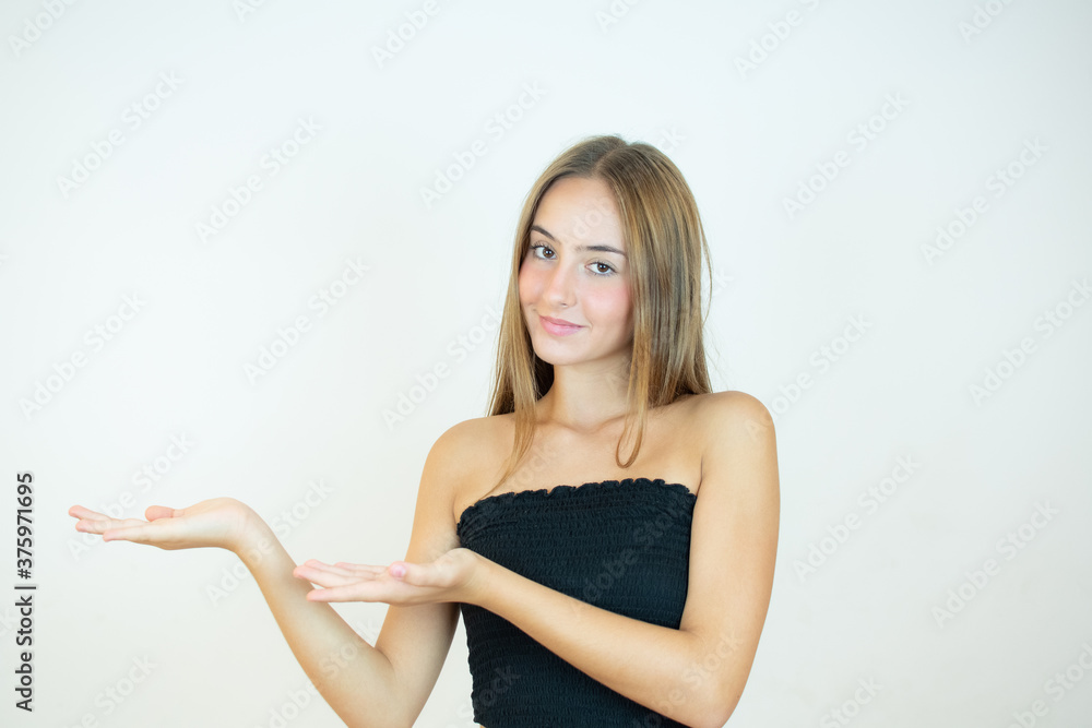 Smiling beautiful girl in black top showing something Smiling beautiful girl in black top showing something