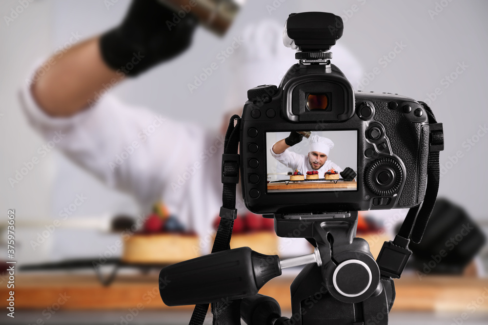 Food photography. Shooting of chef decorating desserts, focus on camera Food photography. Shooting of chef decorating desserts, focus on camera