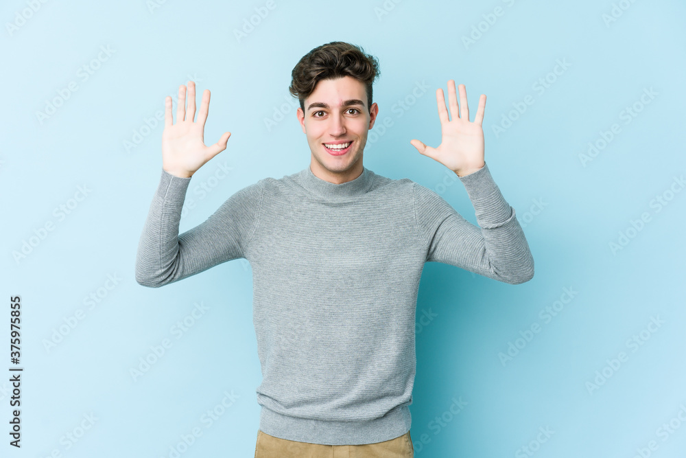 Young caucasian man isolated on blue background receiving a pleasant surprise, excited and raising hands. Young caucasian man isolated on blue background receiving a pleasant surprise, excited and raising hands.