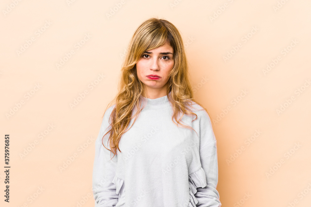 Young blonde caucasian woman blows cheeks, has tired expression. Facial expression concept. Young blonde caucasian woman blows cheeks, has tired expression. Facial expression concept.