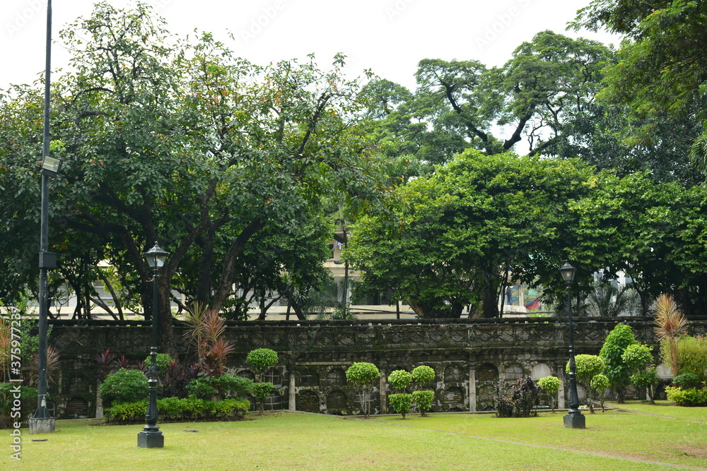 Paco park cemetery and niches wall with trees in Manila, Philippines