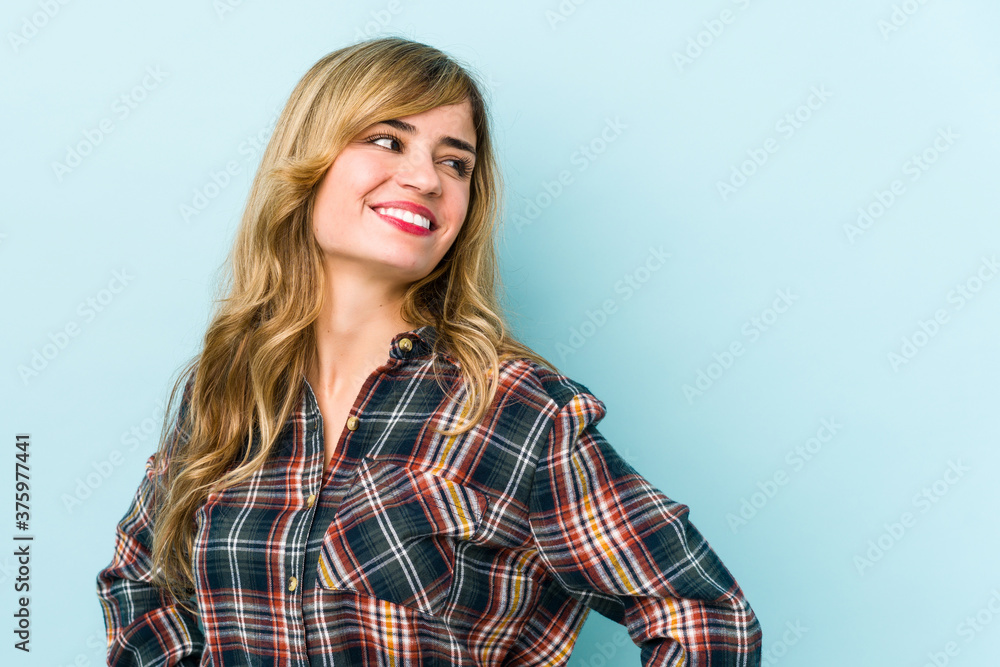 Young blonde caucasian woman laughs happily and has fun keeping hands on stomach. Young blonde caucasian woman laughs happily and has fun keeping hands on stomach.