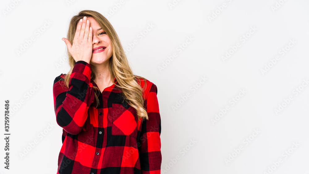 Young cauciasian woman isolated on white background having fun covering half of face with palm. Young cauciasian woman isolated on white background having fun covering half of face with palm.