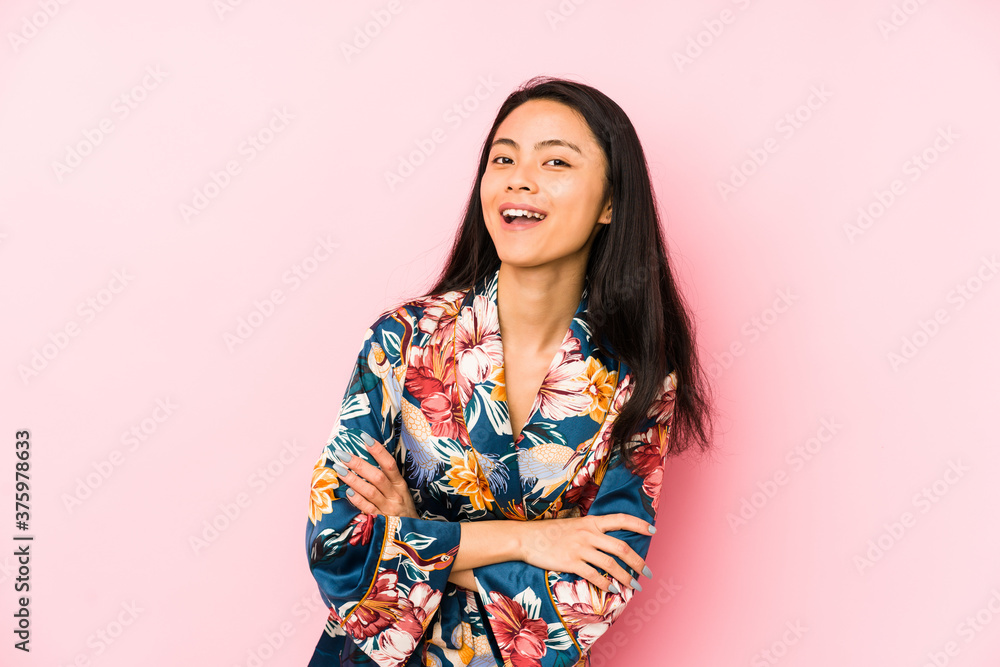 Young chinese woman wearing a asiatic pijama isolated showing a dislike gesture, thumbs down. Disagreement concept. Young chinese woman wearing a asiatic pijama isolated showing a dislike gesture, thumbs down. Disagreement concept.