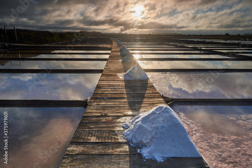 Traditional salt extraction camp (Salinas) with piles of extracted salt at sunrise - Figueira da Foz,Portugal photo