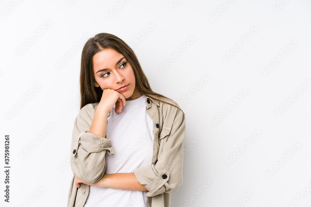Young caucasian woman isolated who feels sad and pensive, looking at copy space. Young caucasian woman isolated who feels sad and pensive, looking at copy space.