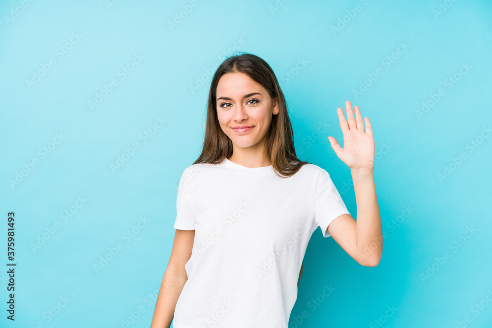 Young caucasian woman isolated smiling cheerful showing number five with fingers. Young caucasian woman isolated smiling cheerful showing number five with fingers.