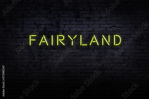 Obraz na plátně Night view of neon sign on brick wall with inscription fairyland