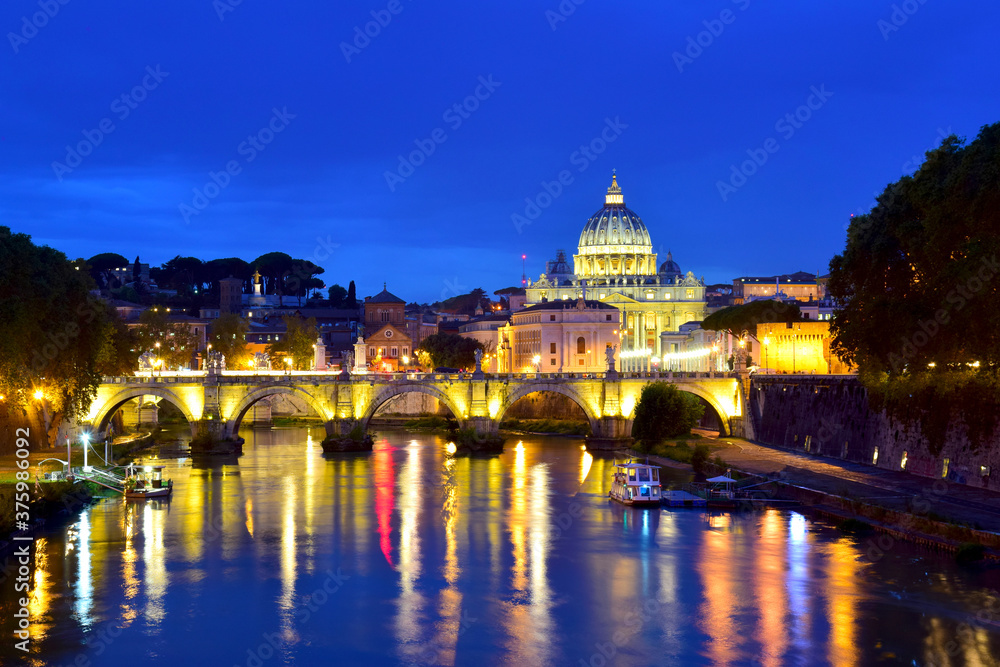 Saint Peter Cathedral and bridge at night in Rome, Italy