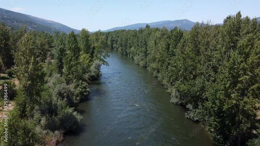 Aerial view over Sil river and a bridge, in O barco de Valdeorras, Galicia, Spain - Reverse, drone shot