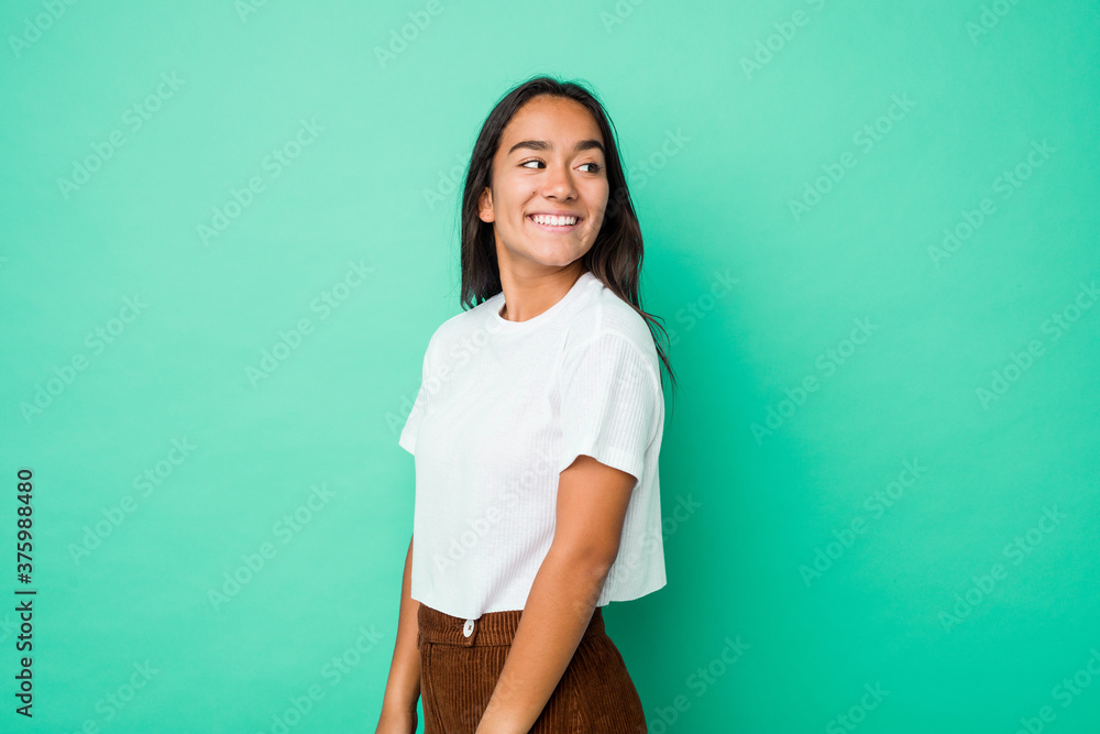 Young mixed race indian woman isolated looks aside smiling, cheerful and pleasant. Young mixed race indian woman isolated looks aside smiling, cheerful and pleasant.