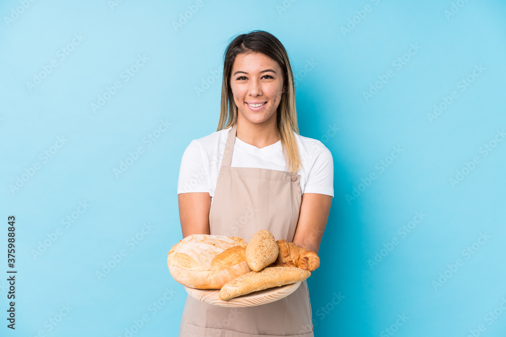 Young caucasian baker woman isolated happy, smiling and cheerful.