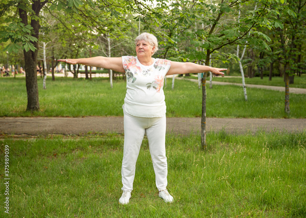 Optimistic old woman exercising for healthy life in open air. Wellness
