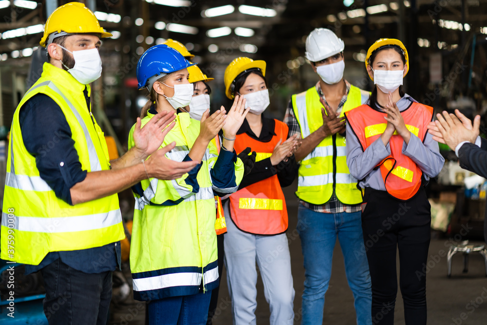 Group of diversity engineers Workers team wear protective face masks for safety in meeting. Success Worker man wearing face mask prevent covid-19 virus and protective hard hat. Group of diversity engineers Workers team wear protective face masks for safety in meeting. Success Worker man wearing face mask prevent covid-19 virus and protective hard hat.