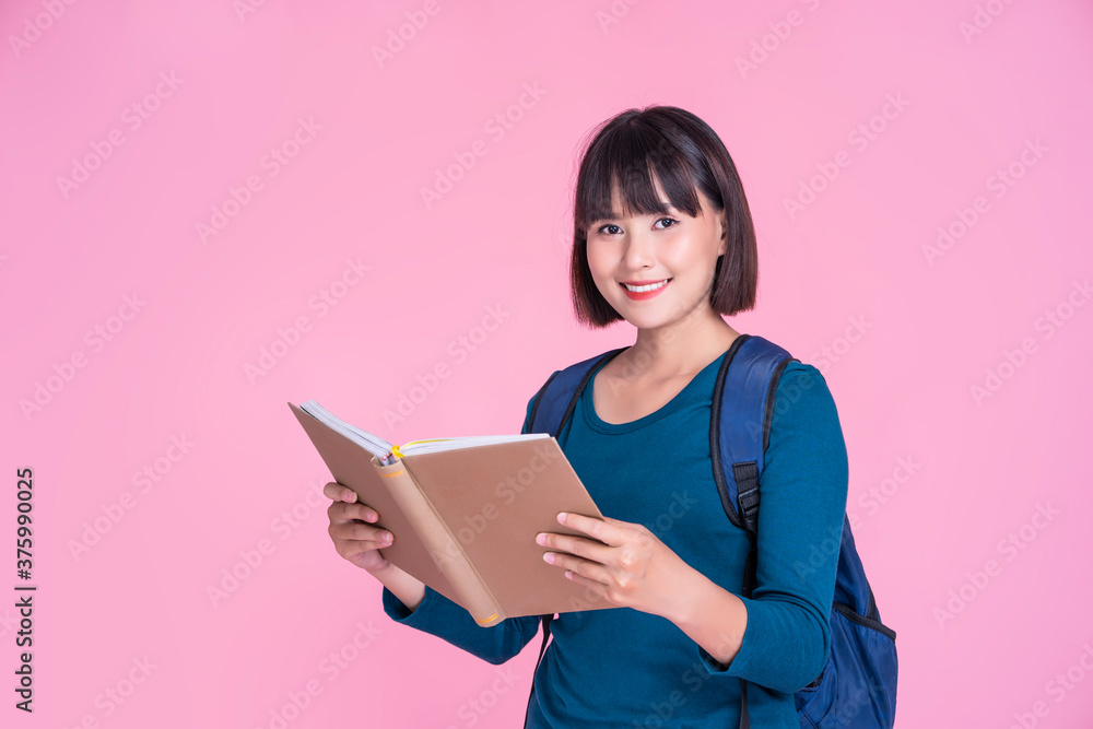 Girl packing school books in bag Stock Photos and Images