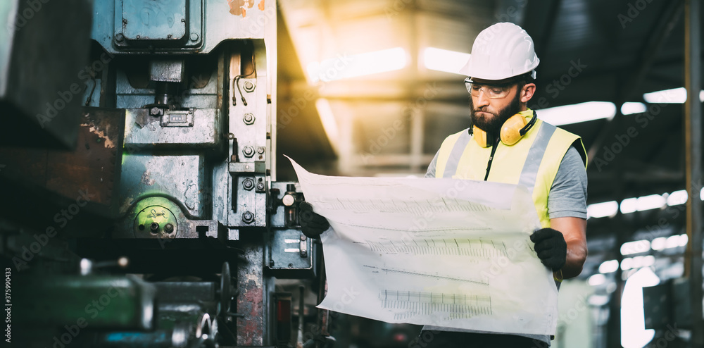 Portrait of mechanical worker working on blueprint. Bearded man worker in building helmet or hard hat for safety. Portrait of mechanical worker working on blueprint. Bearded man worker in building helmet or hard hat for safety.