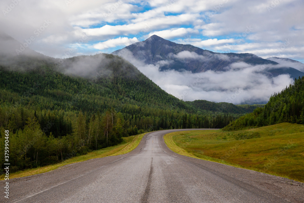Beautiful View of a scenic road in the Northern Rockies during a sunny and cloudy morning sunrise. Taken in British Columbia, Canada. Nature Background Beautiful View of a scenic road in the Northern Rockies during a sunny and cloudy morning sunrise. Taken in British Columbia, Canada. Nature Background