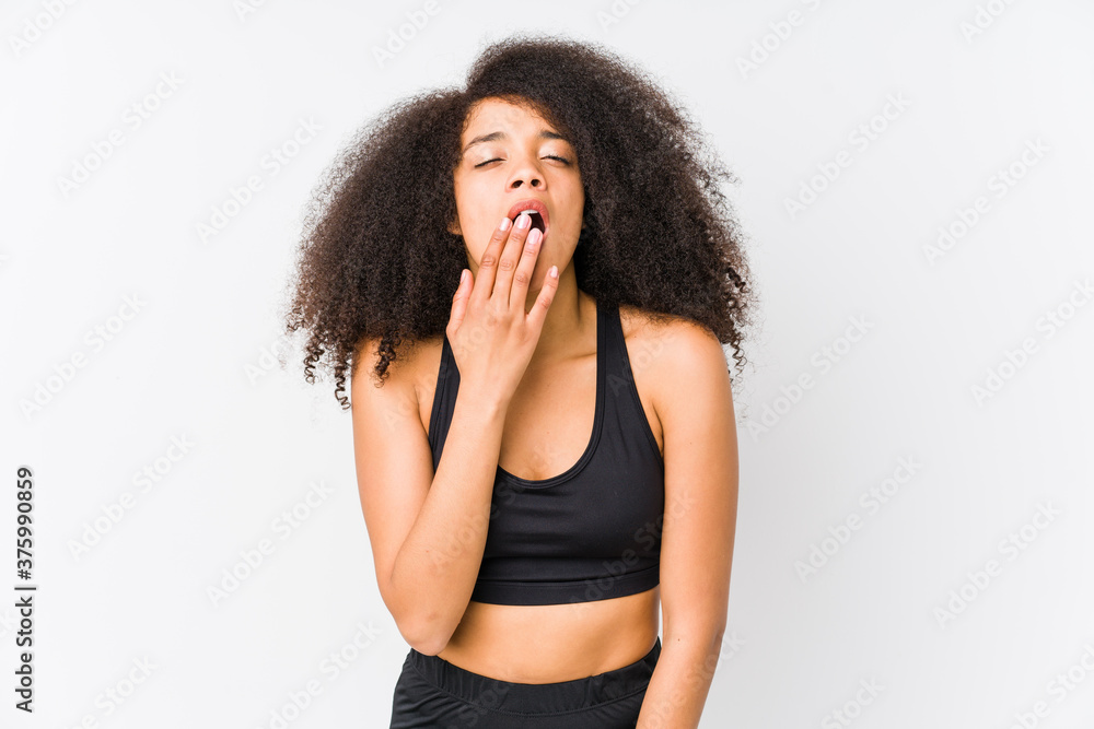 Young african american sporty woman yawning showing a tired gesture covering mouth with hand. Young african american sporty woman yawning showing a tired gesture covering mouth with hand.