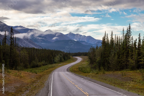Beautiful View of a scenic road in the Northern Rockies during a sunny and cloudy morning sunrise. Taken in British Columbia, Canada. Nature Background © edb3_16