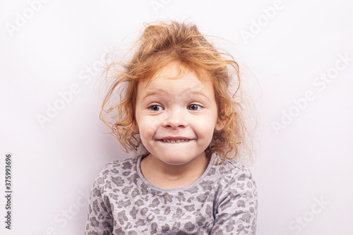 portrait of a happy little red-haired girl isolated on white background