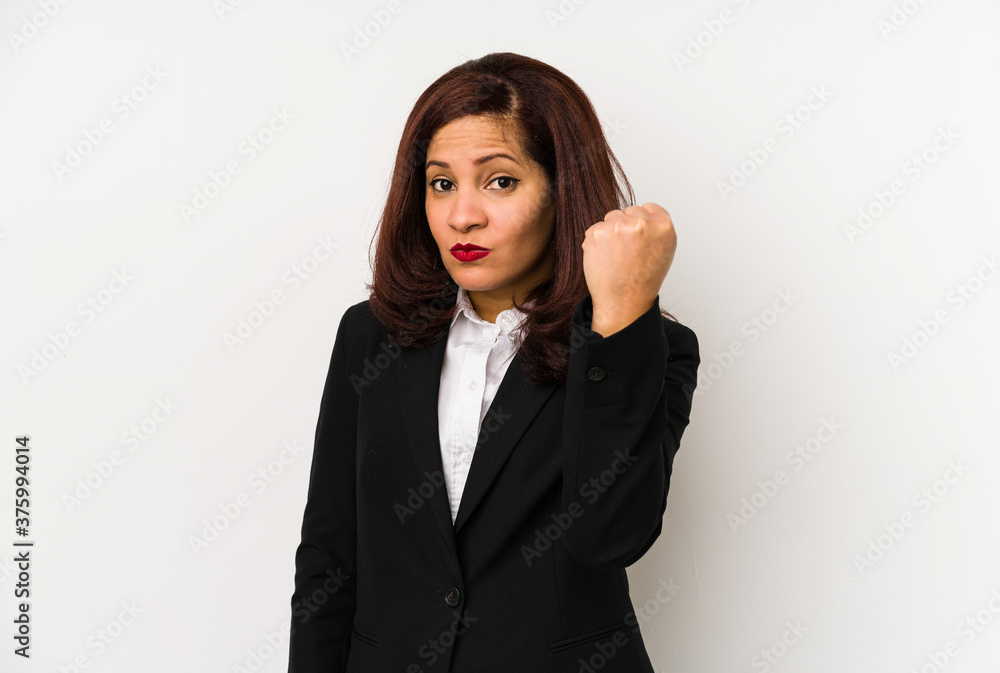 Middle age latin business woman isolated showing fist to camera, aggressive facial expression. Middle age latin business woman isolated showing fist to camera, aggressive facial expression.