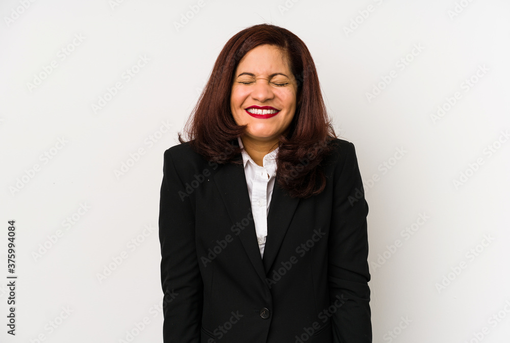 Middle age latin business woman isolated laughs and closes eyes, feels relaxed and happy. Middle age latin business woman isolated laughs and closes eyes, feels relaxed and happy.