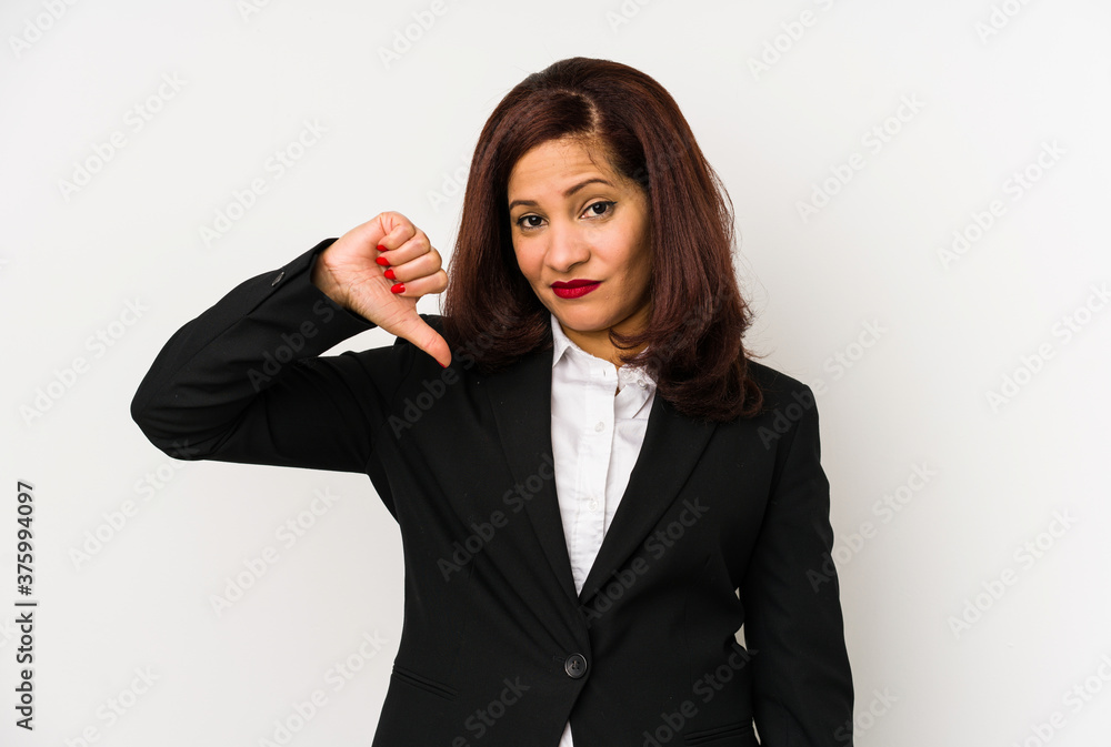 Middle age latin business woman isolated showing a dislike gesture, thumbs down. Disagreement concept. Middle age latin business woman isolated showing a dislike gesture, thumbs down. Disagreement concept.