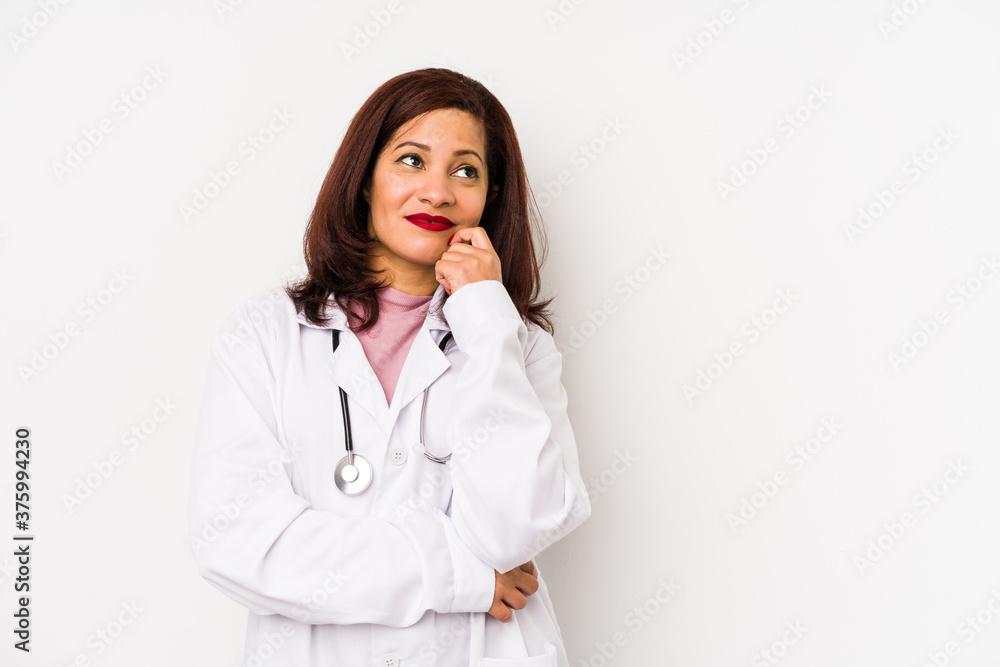 Middle age latin doctor woman isolated looking sideways with doubtful and skeptical expression. Middle age latin doctor woman isolated looking sideways with doubtful and skeptical expression.