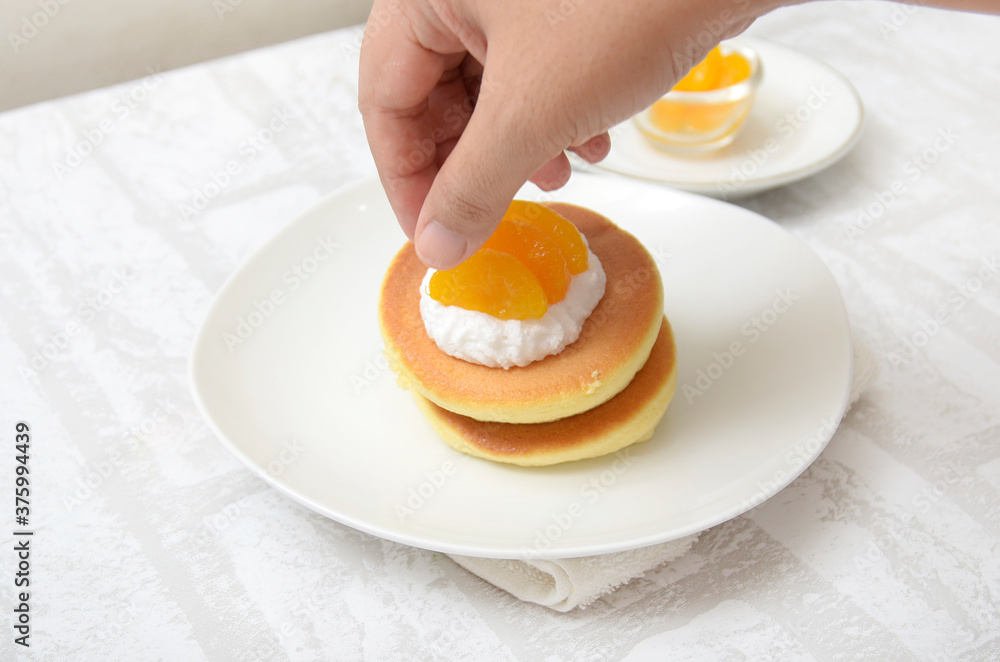 Souffle Pancake ready in plate, several slice orange for topping Souffle Pancake ready in plate, several slice orange for topping