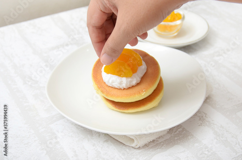 Souffle Pancake ready in plate, several slice orange for topping