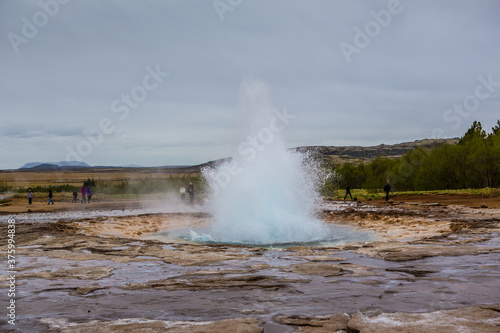 The Strokkur Geyser in Iceland, on a cloudy day.