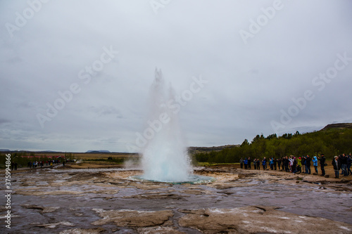The Strokkur Geyser in Iceland, on a cloudy day.