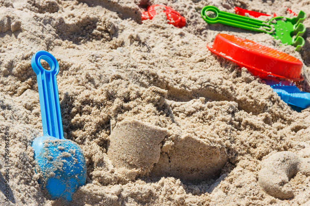 Different shapes made of sand and children toys for playing on beach. Vacation time and child development Different shapes made of sand and children toys for playing on beach. Vacation time and child development