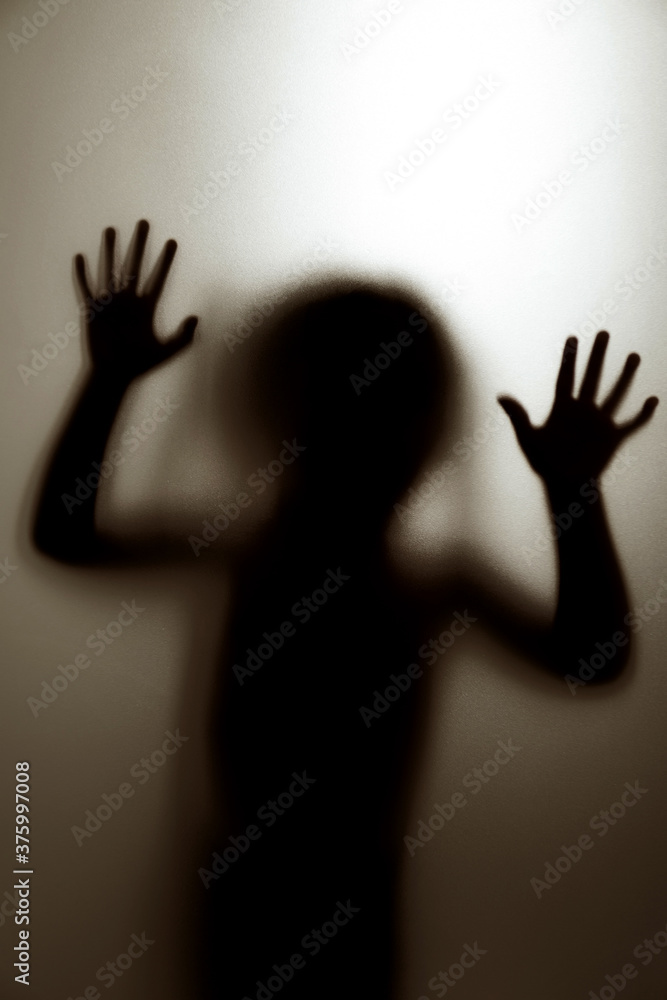 Ghost concept shadow of a child behind the matte glass blurry hand and body soft focus. - obrazy, fototapety, plakaty 